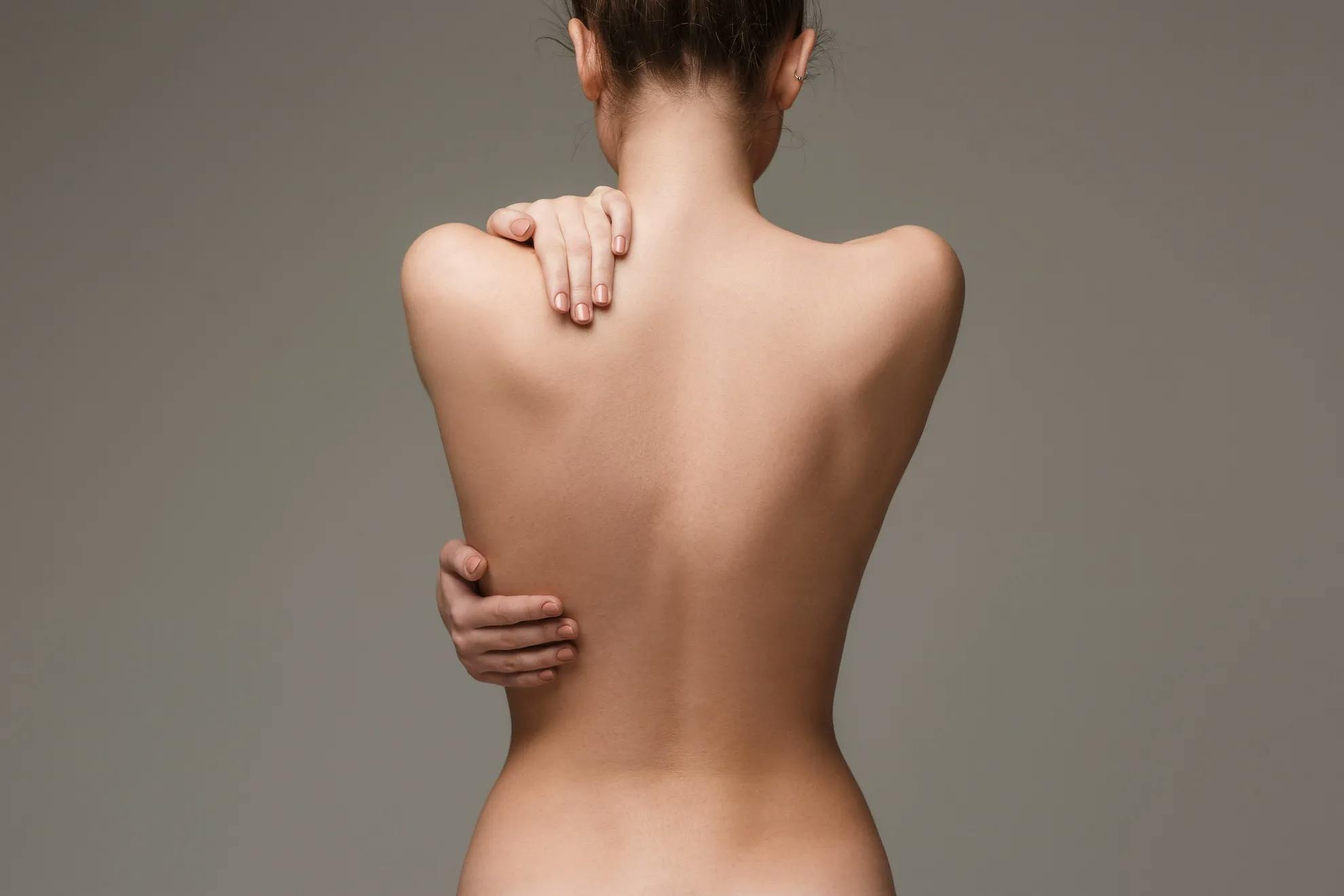 A woman showing her back after a body treatment